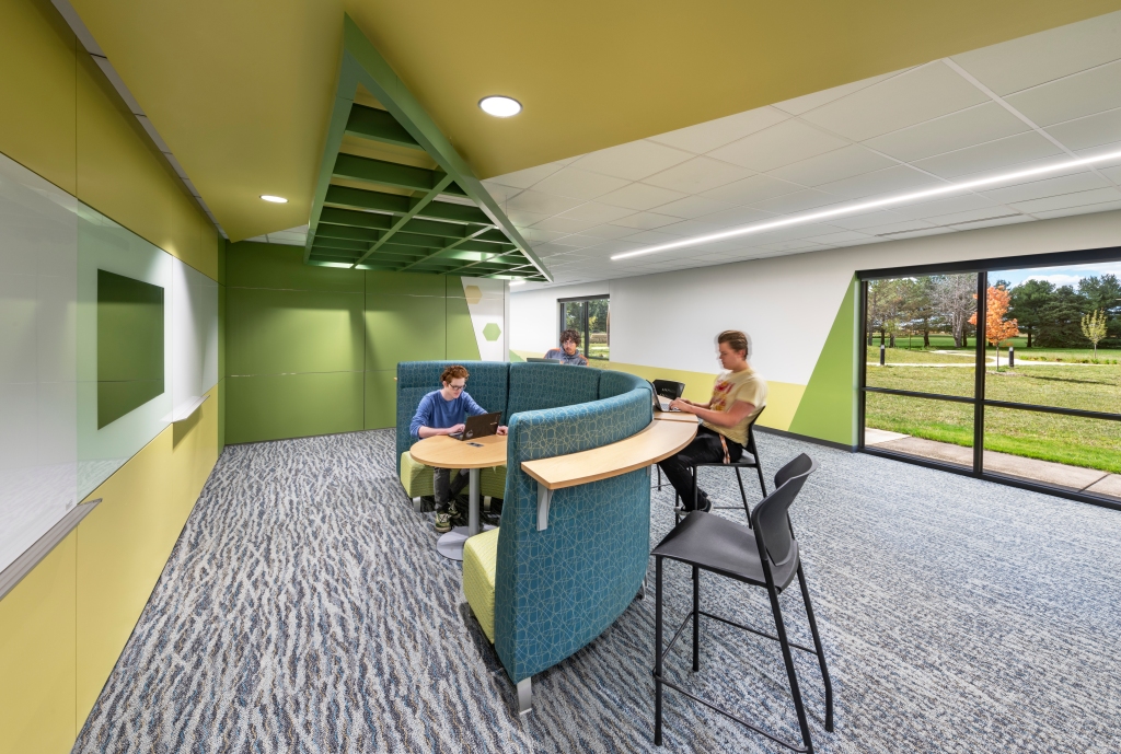 Green and yellow commons area with students working in small group